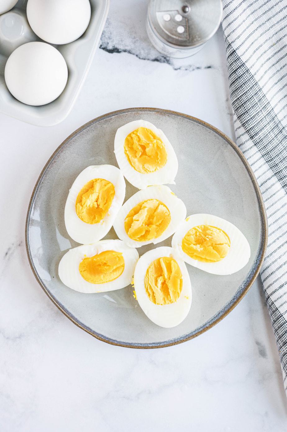 A plate is presented with 6 pieces of halved hard boiled eggs.