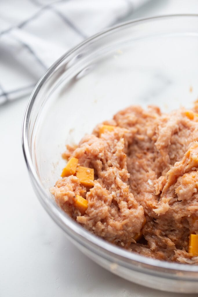 A bowl of ground chicken for ground chicken burgers