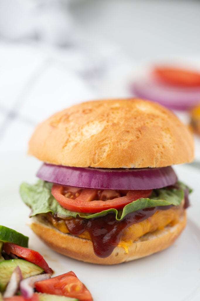 BBQ Chicken Burger with a Gluten free roll, tomato, onion, lettuce 