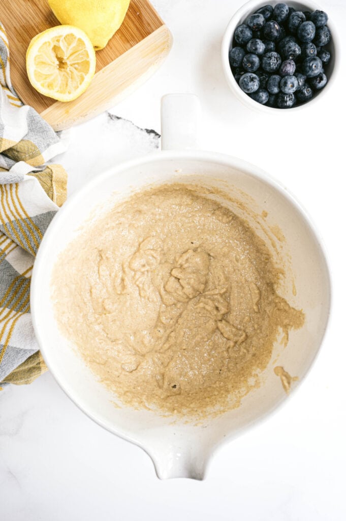 Overhead image of batter for the lemon blueberry bread, lemon, and blueberries