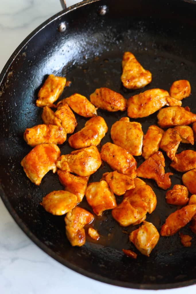 Bite-sized pieces of buffalo style chicken in a pan made with boneless, skinless chicken tenderloins.