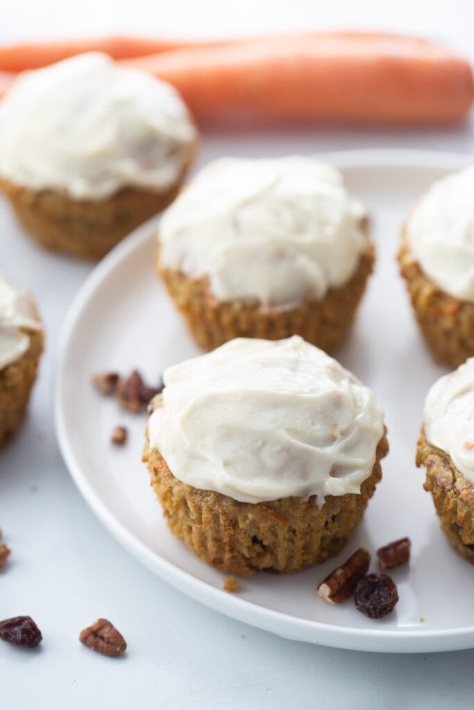 Carrot Cake Muffins with cream cheese frosting on a round white plate
