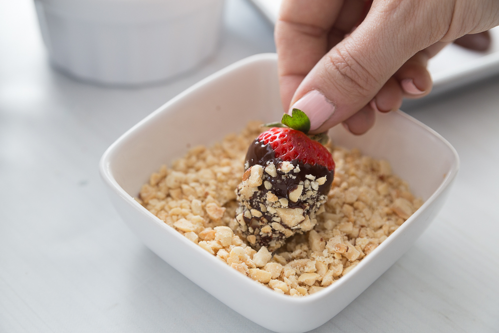 Dipping Chocolate Covered Strawberries in Chopped Peanuts