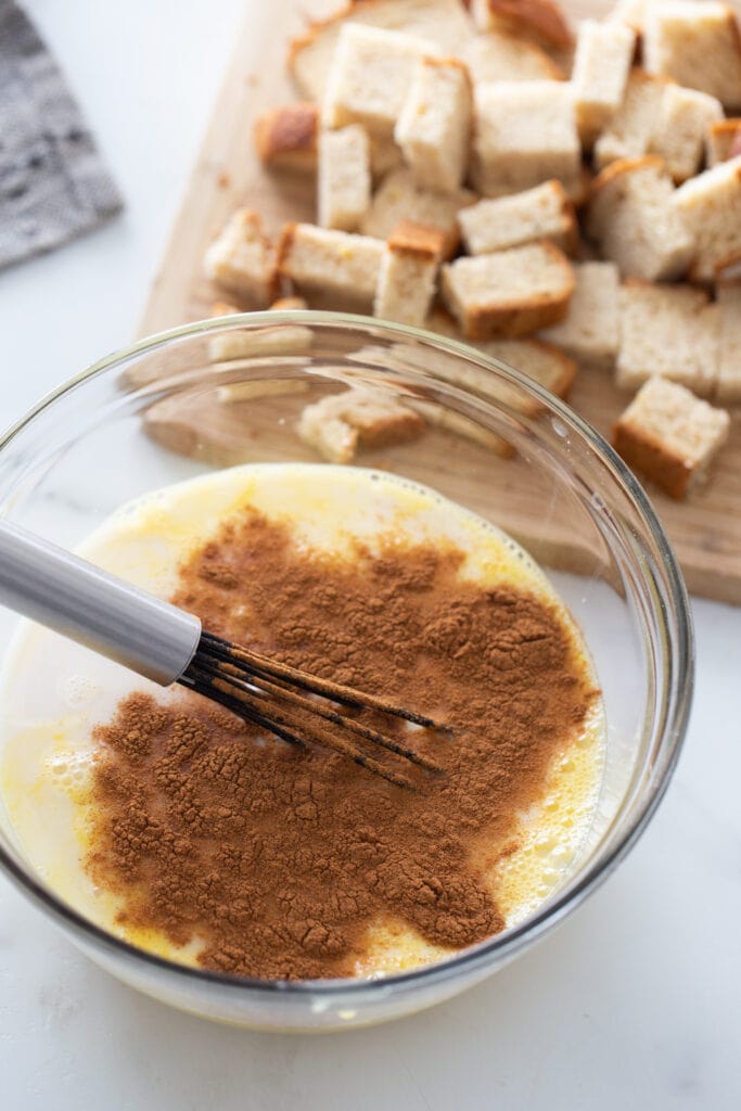 The ingredients for French toast are on a white surface.