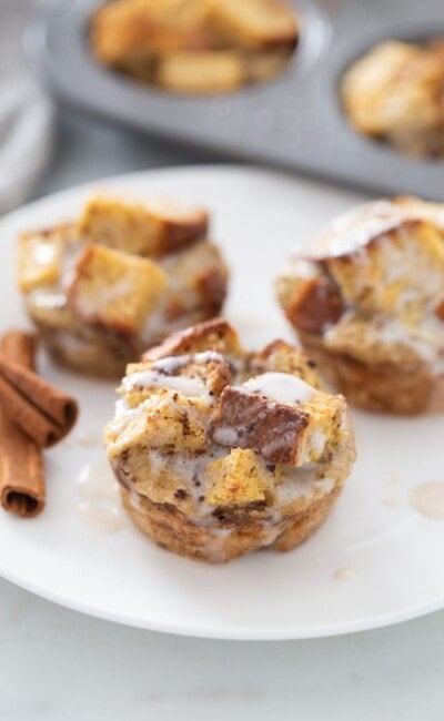 Three French toast cups are on a white plate.