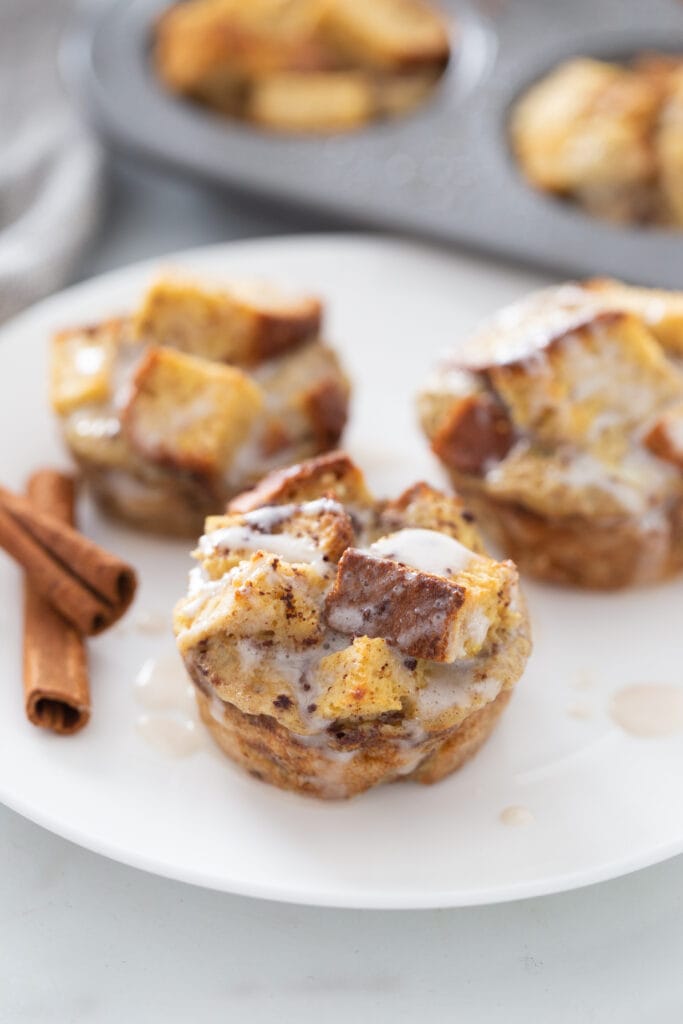 Three French toast cups are on a white plate.