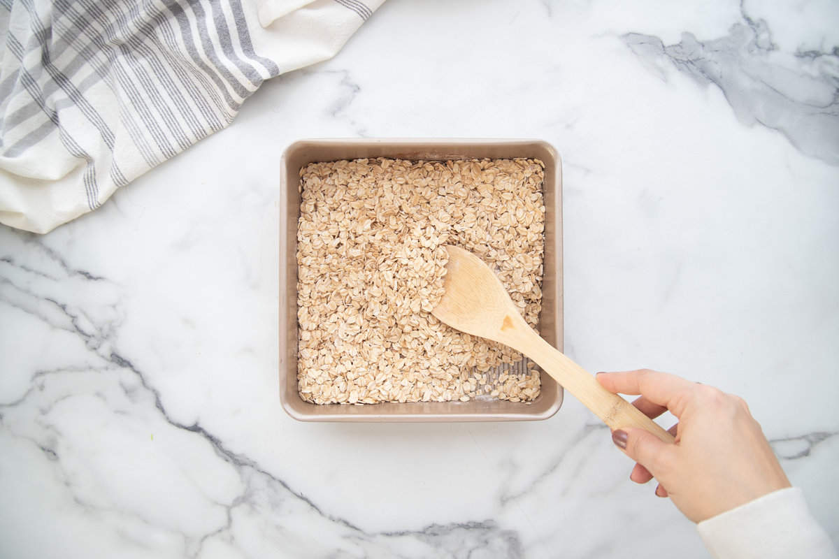 Dry ingredients in a square baking dish for baked oats.