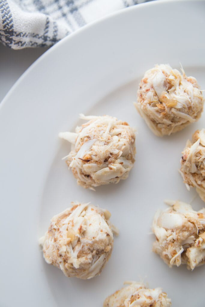 Mini crab cake appetizers on a white plate 