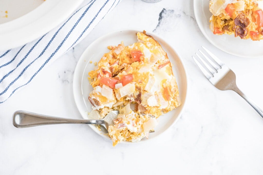 Two plates of eggs on a white table