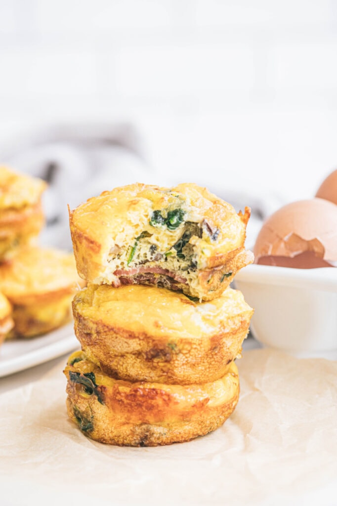 Three breakfast bites are stacked on top of one another on a white surface.