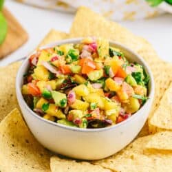 Fresh peach salsa with cilantro, peppers, and avocado.