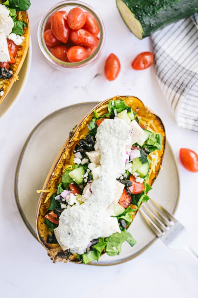 Overhead image of roasted spaghetti squash stuffed with veggies, diced chicken, and sauce.