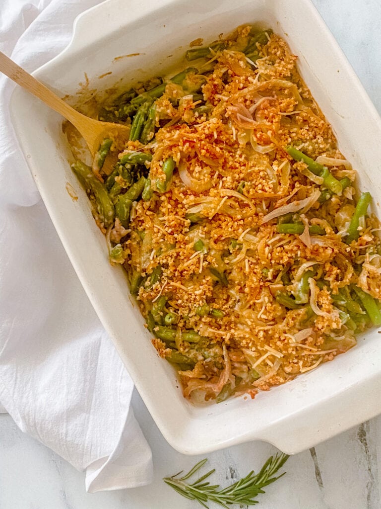 Overhead photo: green bean casserole with crispy onions and mushroom alfredo, golden brown and ready for serving.