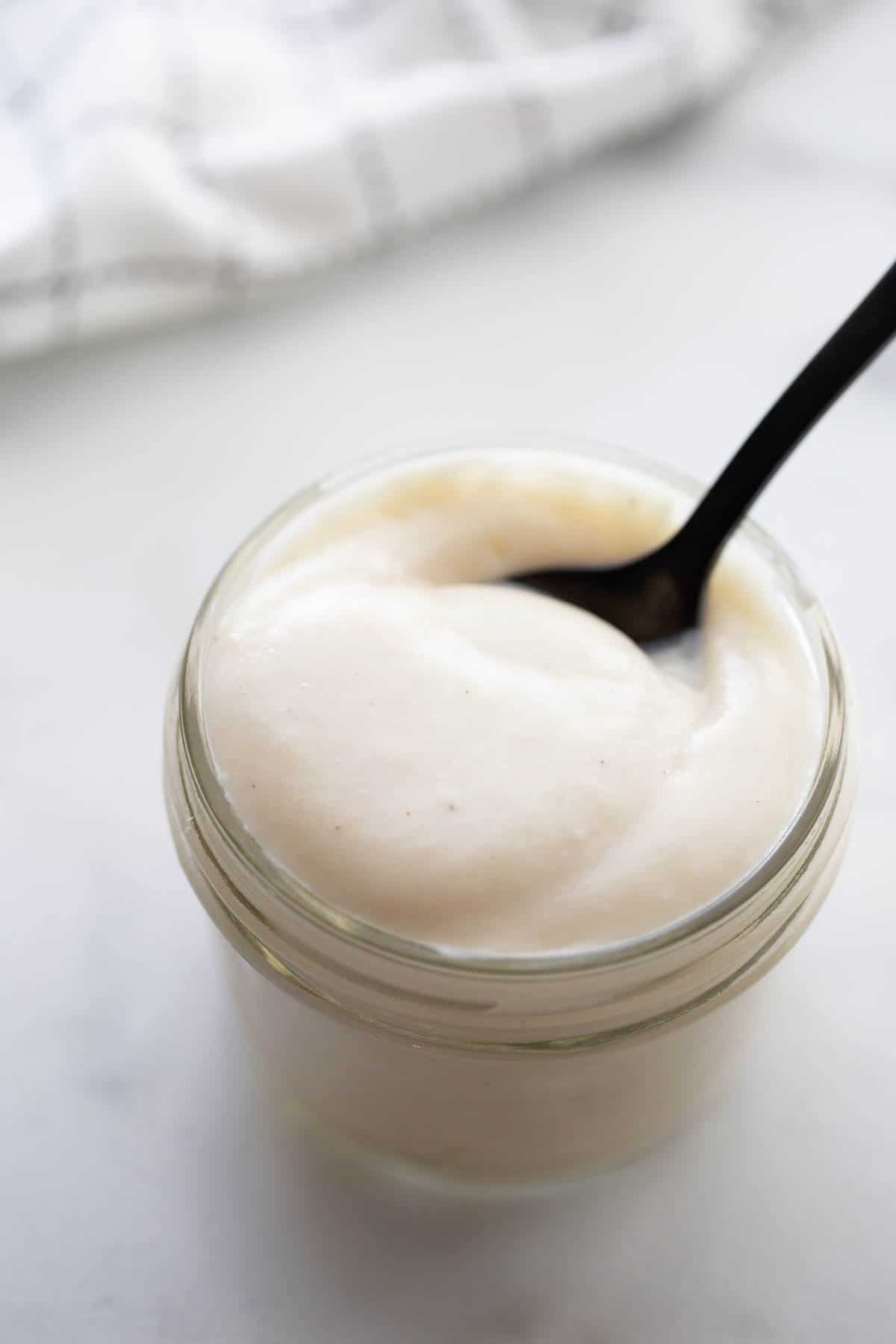 A small mason jar with a homemade cream of chicken soup substitute