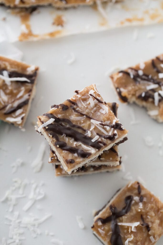 Overhead photo of a stack of Healthy Samoas Cookie Bars with more bars scattered around the stack.