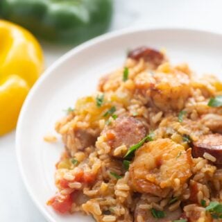 A serving of jambalaya is presented on a white plate.