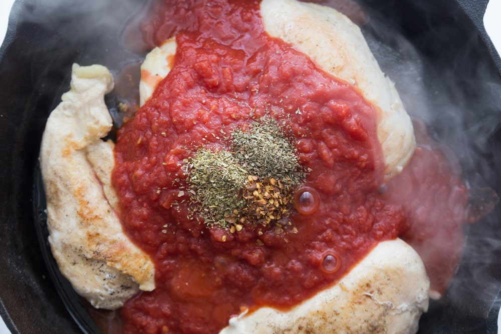 Cast Iron Skillet with Chicken, Sauce and Herbs