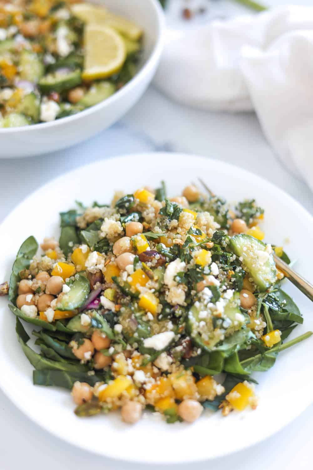 Bowl of the viral Jennifer Aniston Salad with chickpeas, quinoa, fresh veggies, and a lemon vinaigrette.