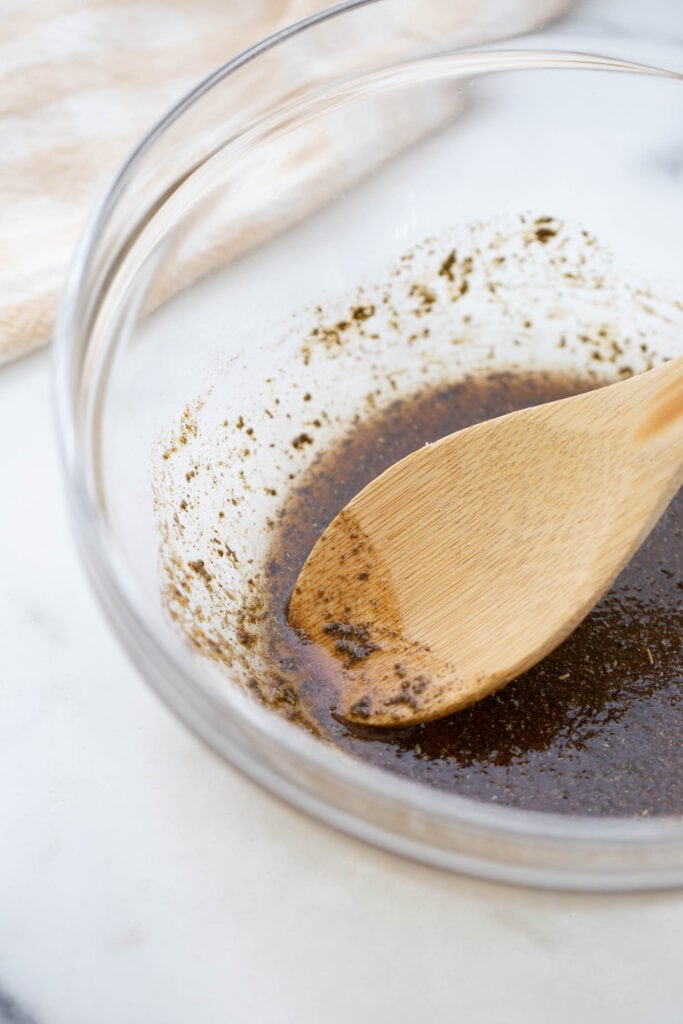 Olive oil, spices, and pure maple syrup in a glass bowl.