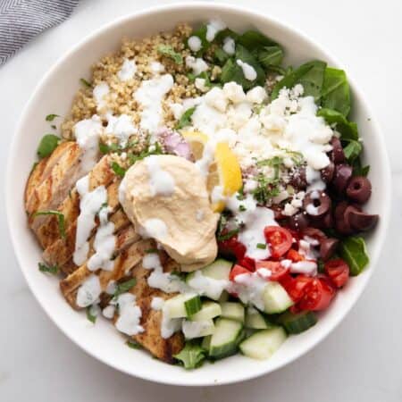 Mediterranean Bowl with chicken, hummus, veggies, and tzatziki dressing.