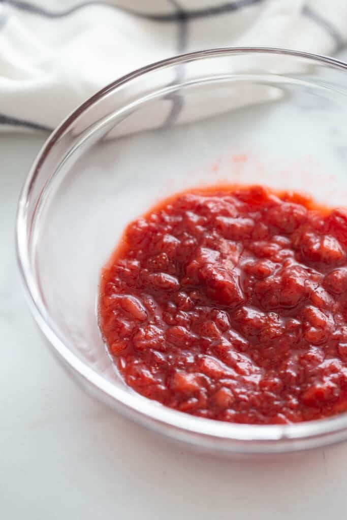 Cooked strawberries in a glass bowl