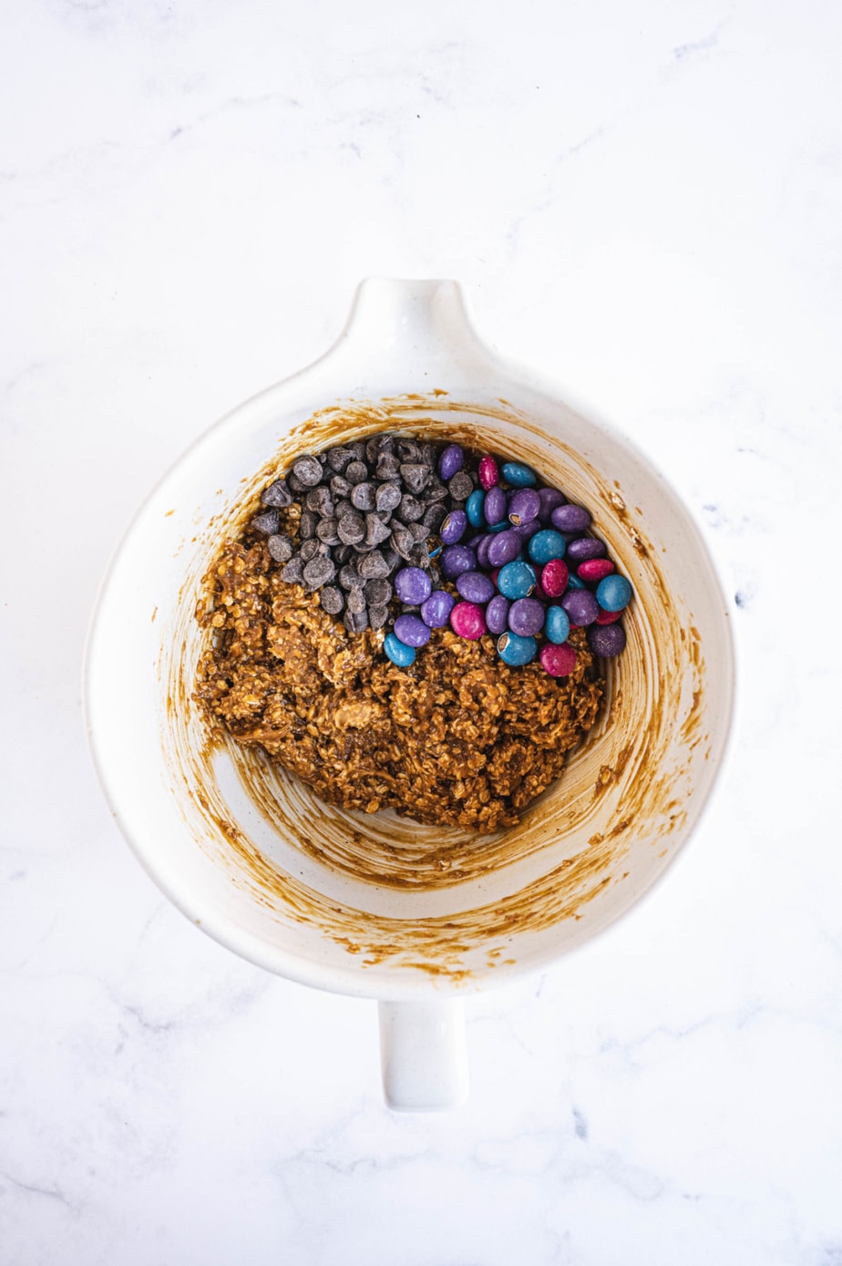 More ingredients have been added to the white mixing bowl.