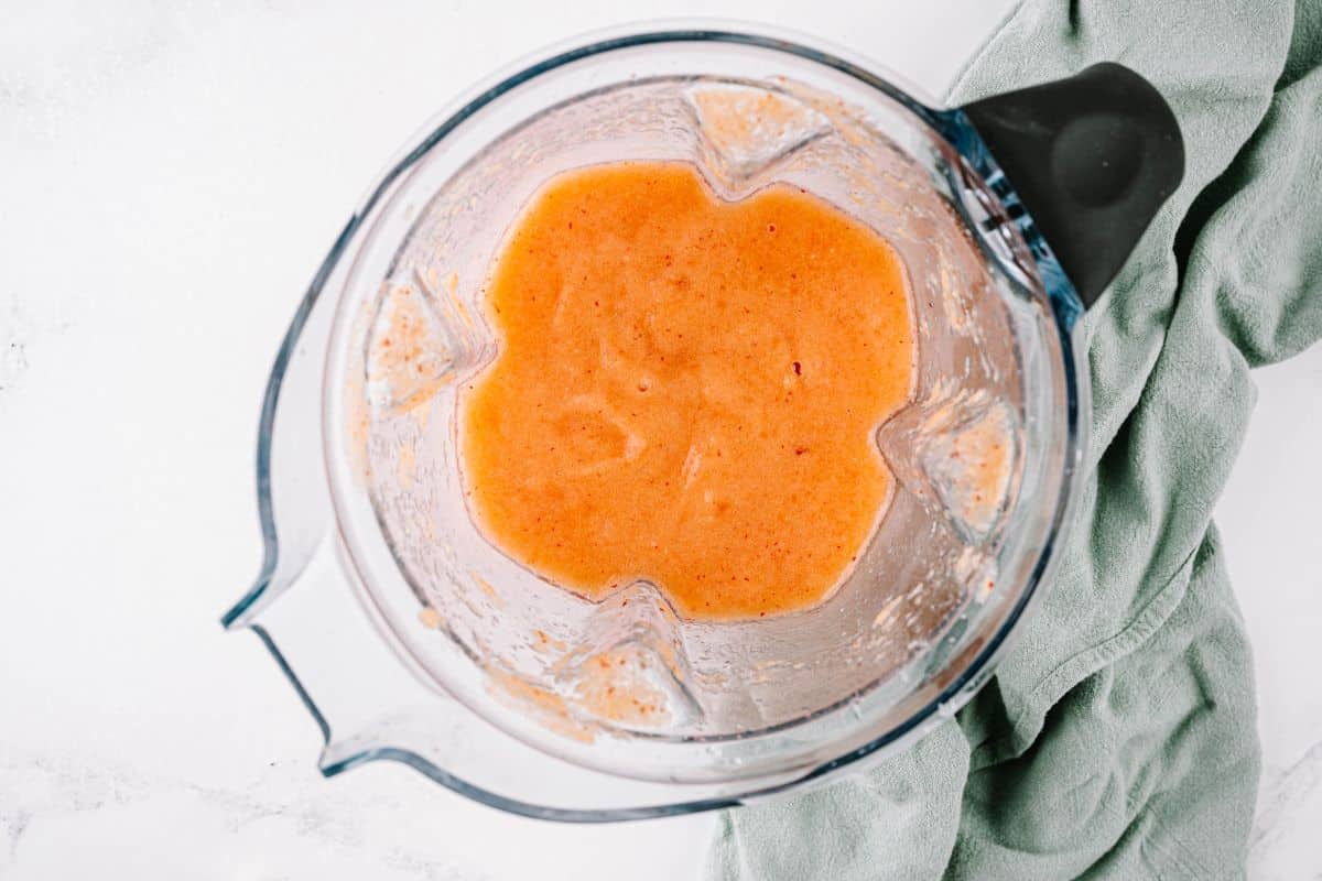 A blender with homemade peach margarita.