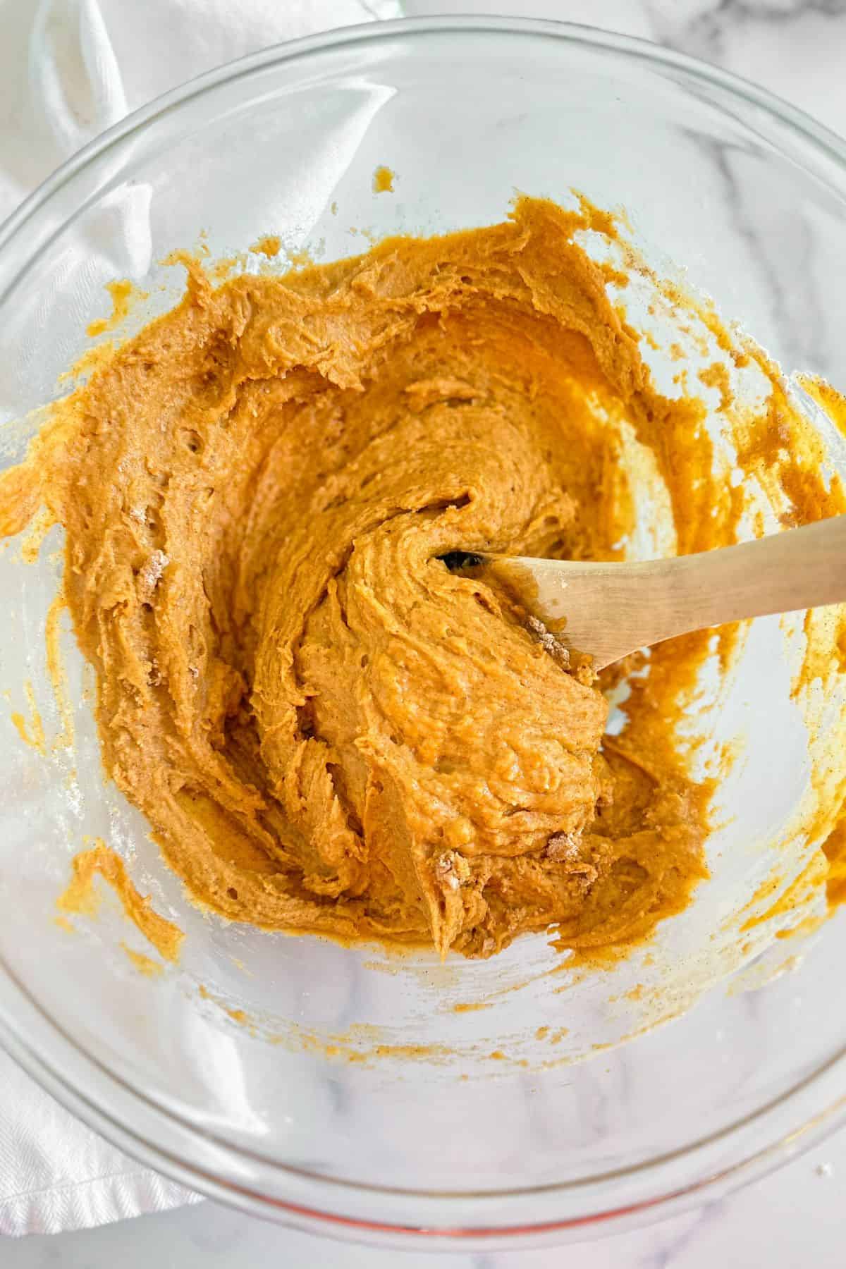 Pumpkin muffin batter in a glass bowl.