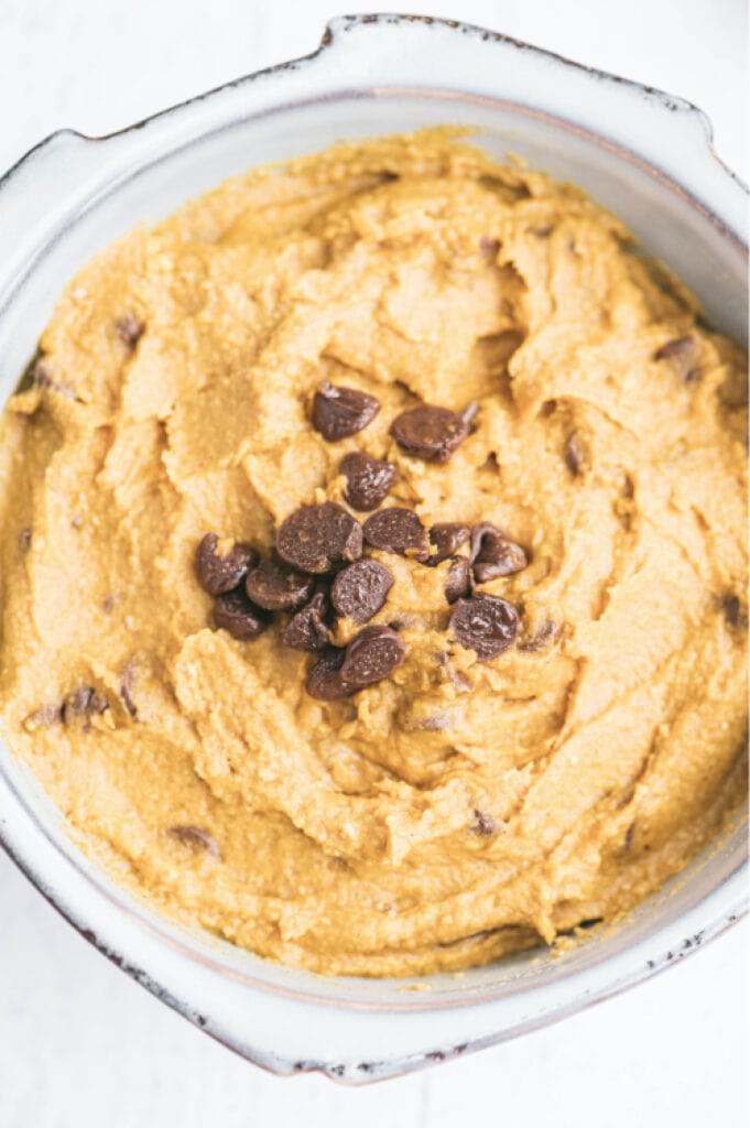 overhead image: white bowl with pumpkin and white bean dairy free hummus