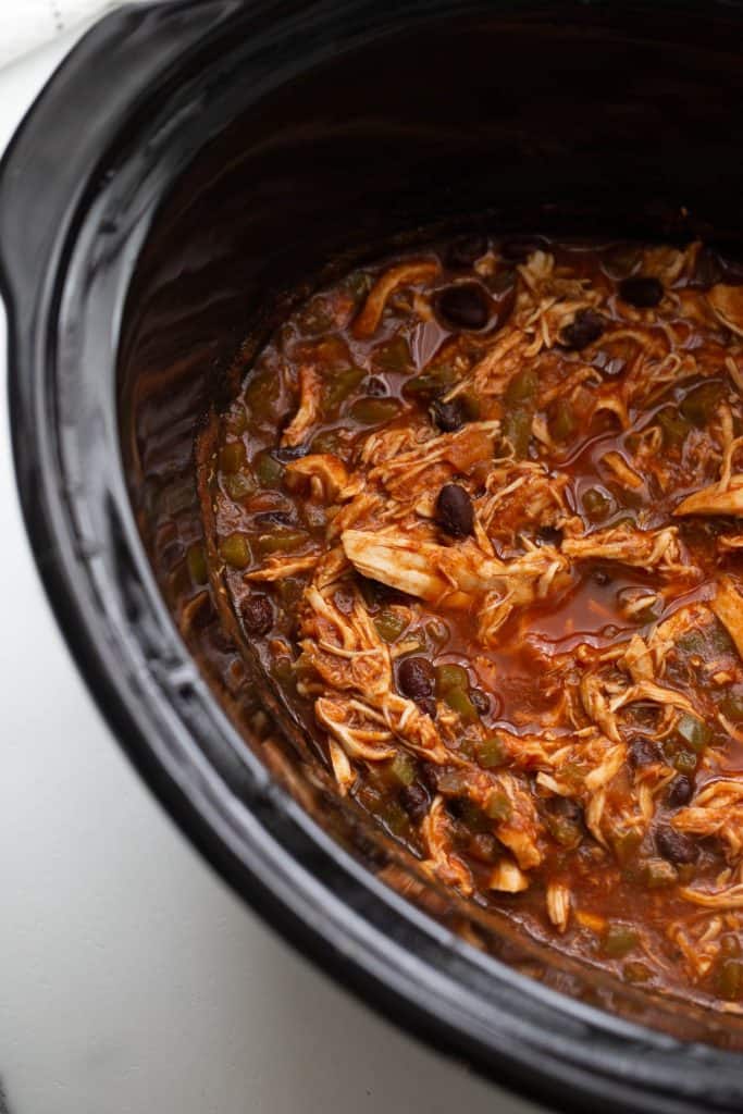 Shredded chicken in enchilada sauce with beans and bell peppers.