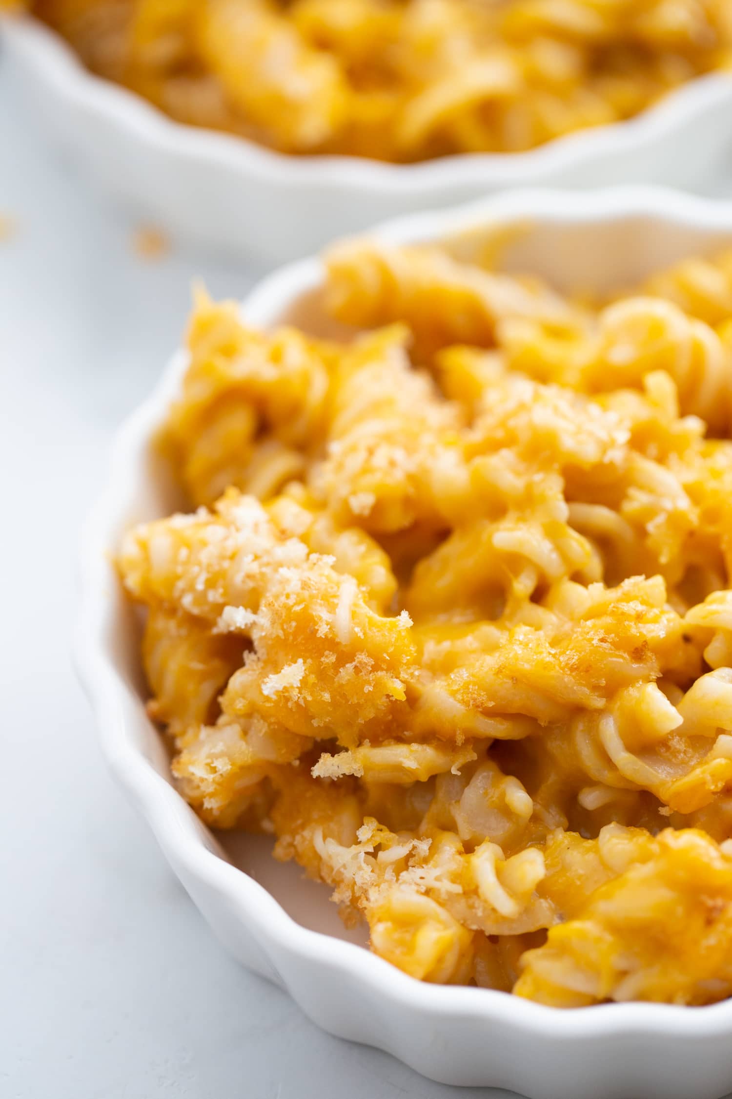 close up photo of mac and cheese in a white ramekin