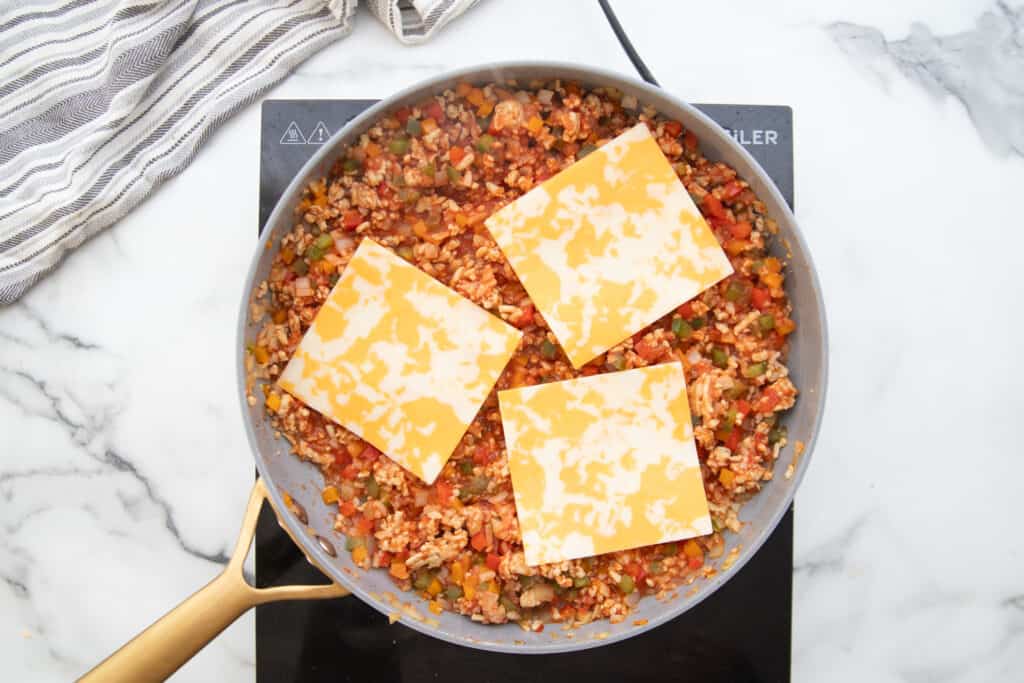 Stuffed Pepper skillet topped with three pieces of Monterey Jack Cheese.