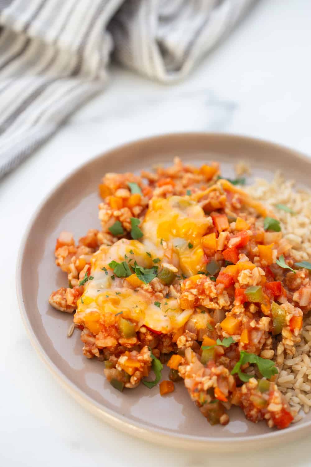 This low carb stuffed pepper skillet recipe has all the flavors of stuffed peppers without the fuss!  It's high protein, full of veggies, and made entirely in one skillet and the whole thing is ready in under 30 minutes.  