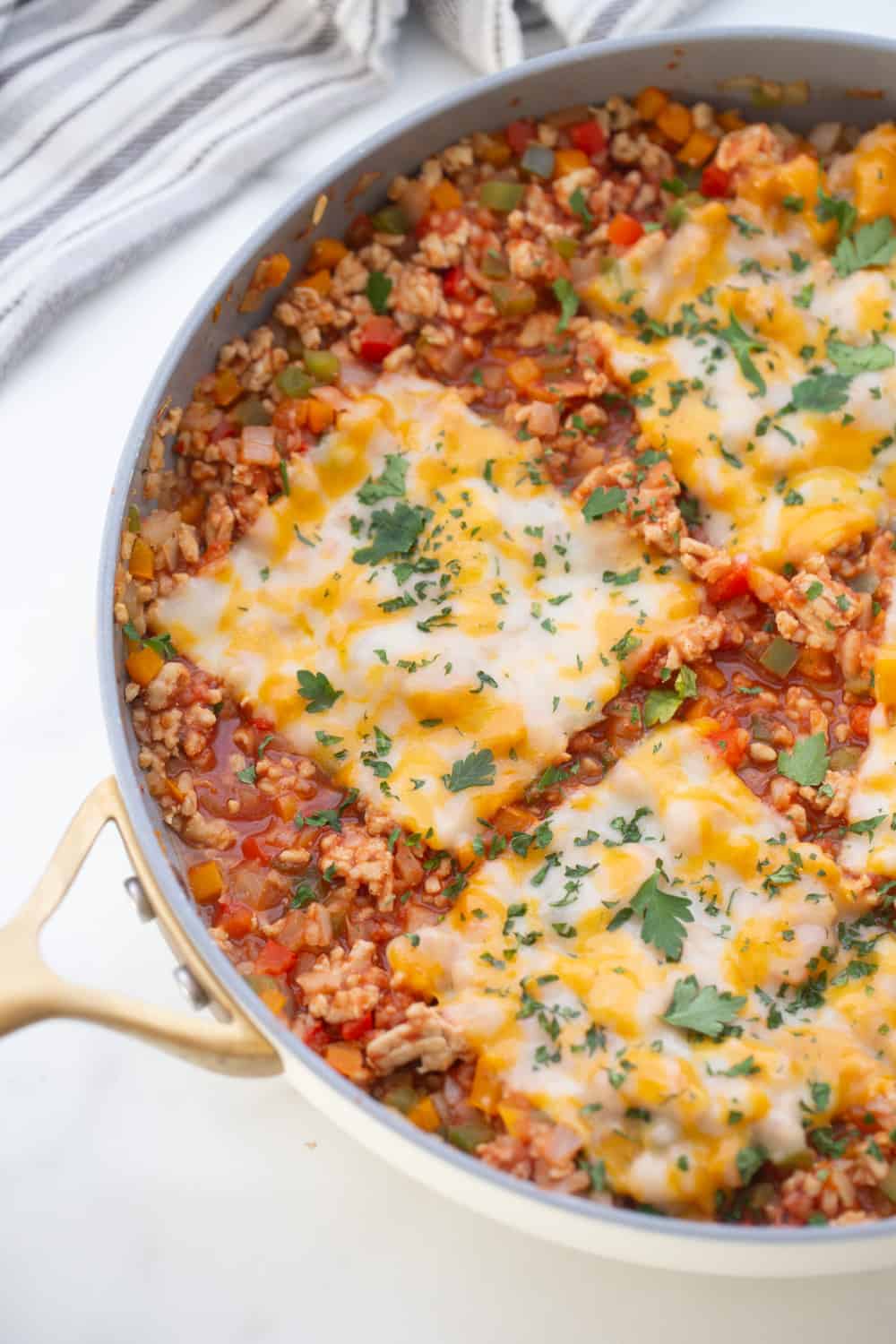 Stuffed Pepper skillet topped with three pieces of Monterey Jack Cheese.