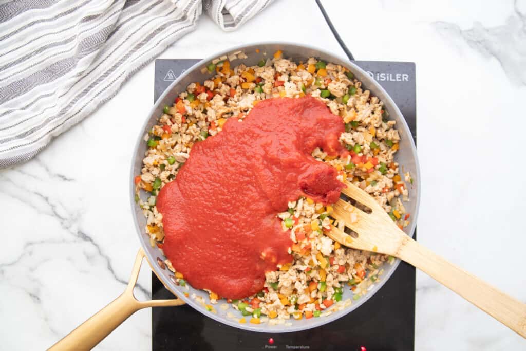 Stuffed Pepper skillet with tomato sauce on top.